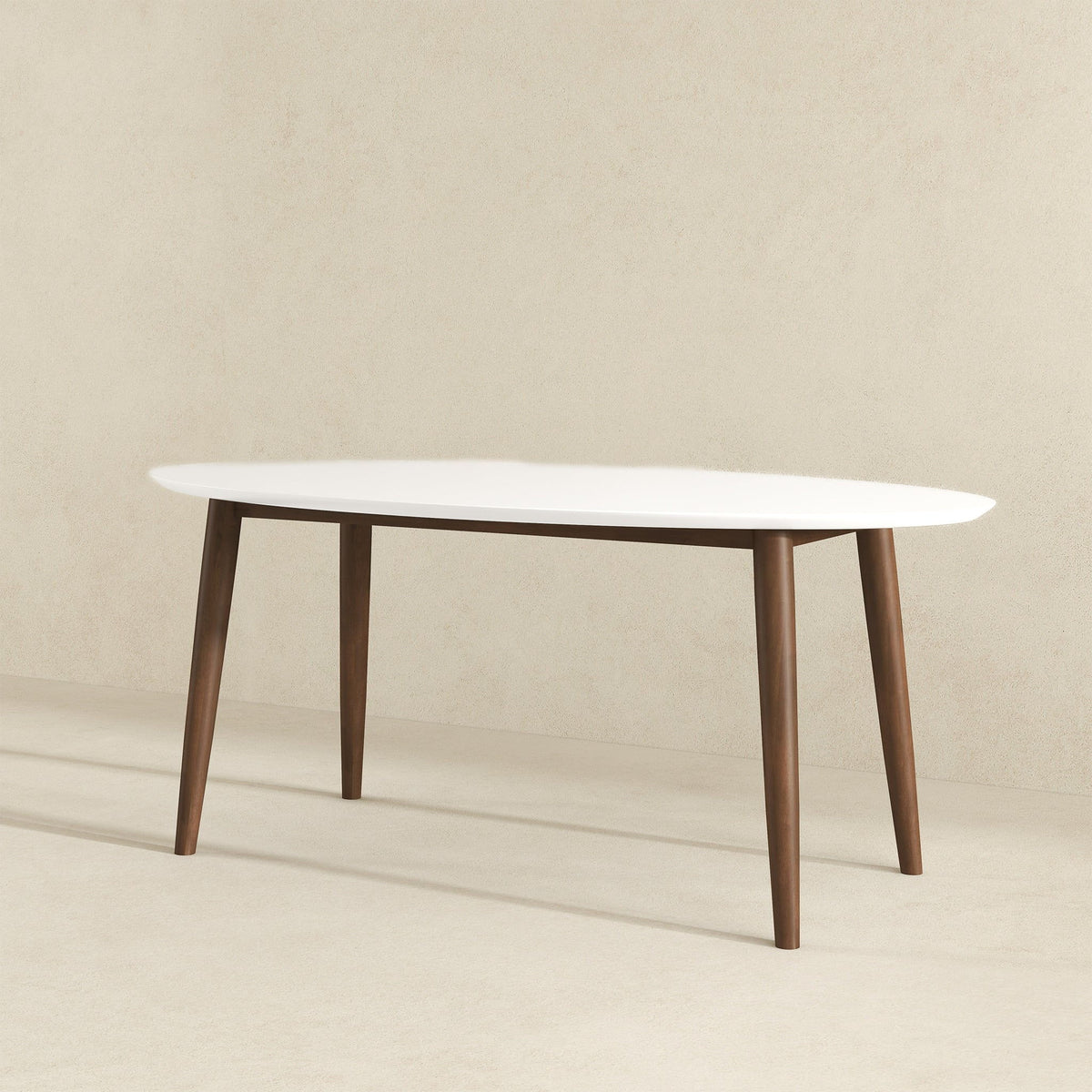 White oval dining table with four tapered wood legs