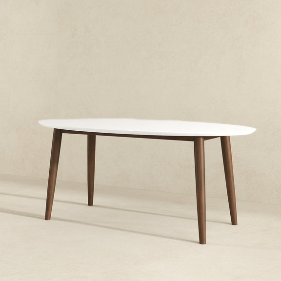 White oval dining table with four tapered wood legs