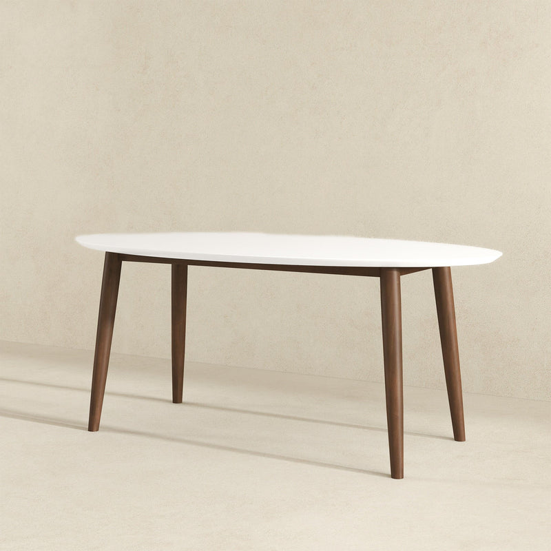 White oval dining table with four tapered wood legs