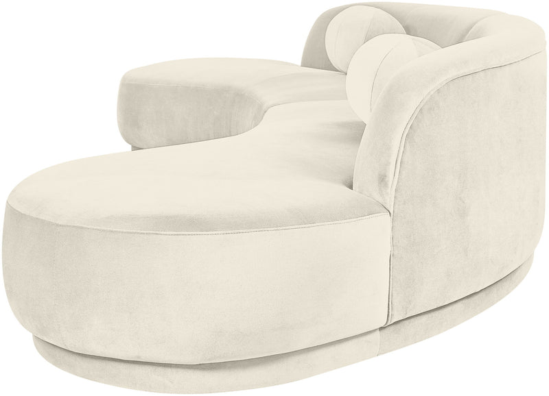 Light beige velvet sectional sofa with rounded arms and cushioned chaise