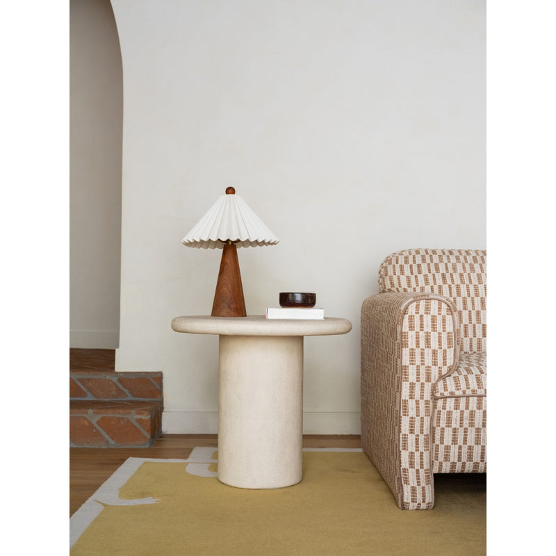 Cream outdoor side table with flat round top and upright cylindrical base.