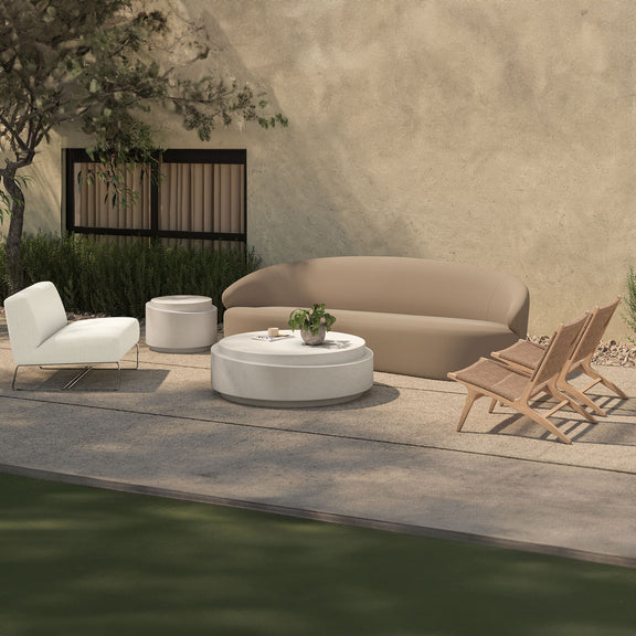Beige outdoor lounge chair with curved back cushion and two tan wooden lounge chairs
