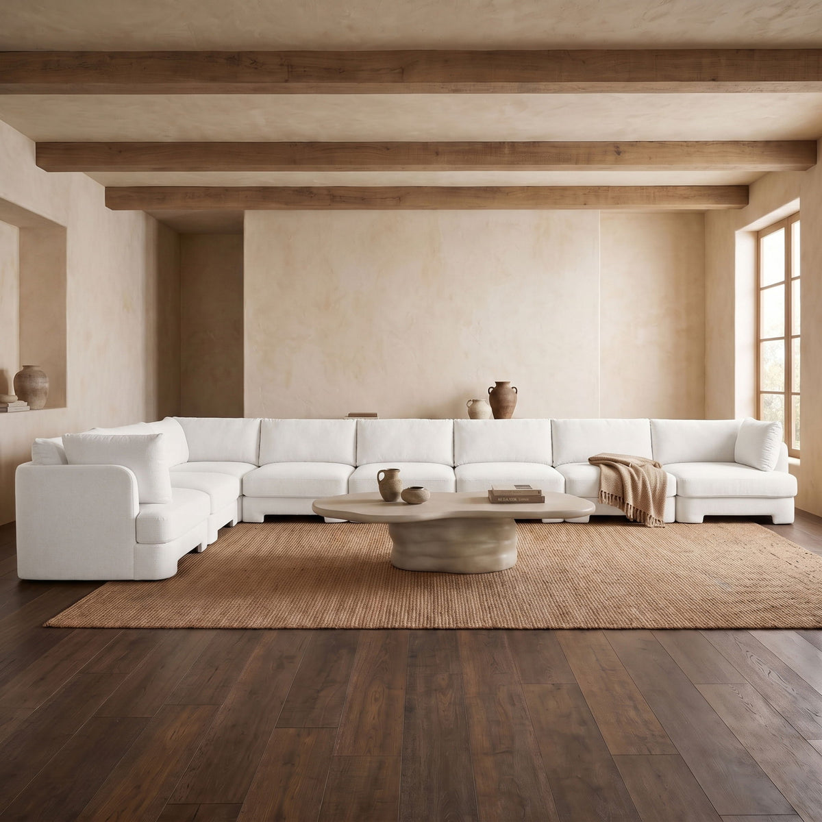 White L-shaped velvet sectional sofa set in a living room layout with matching cushions