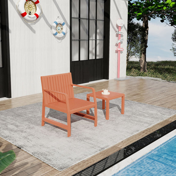 Orange outdoor chair with matching side table, on gray rug