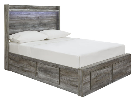 Gray panel bed with slatted headboard and drawer-front panels, styled with white linens