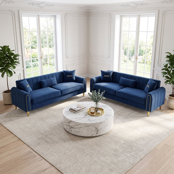 Pair of blue three-seat sofas with tufted arms and gold-tone feet, shown from the front