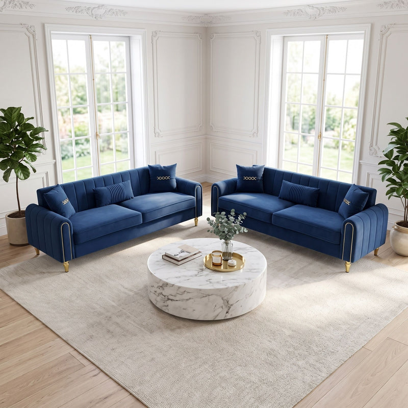 Pair of blue three-seat sofas with tufted arms and gold-tone feet, shown from the front