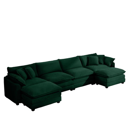 Dark green modular sectional sofa with ottoman chaise and multiple throw pillows
