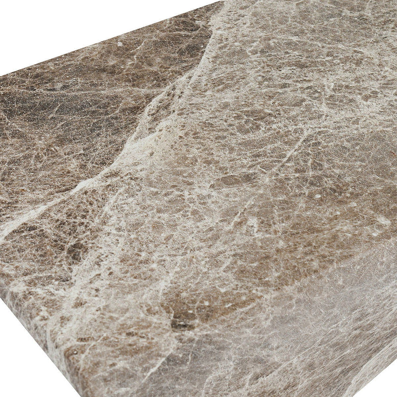 Concrete accent table surface close-up, speckled brown and ivory textured finish