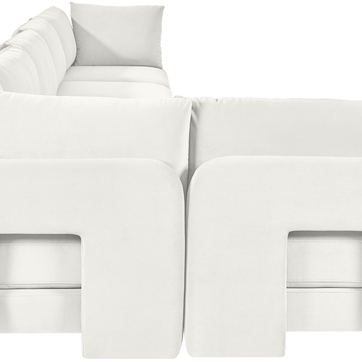 White velvet L-shaped sectional sofa with square armrests and tufted back cushions.