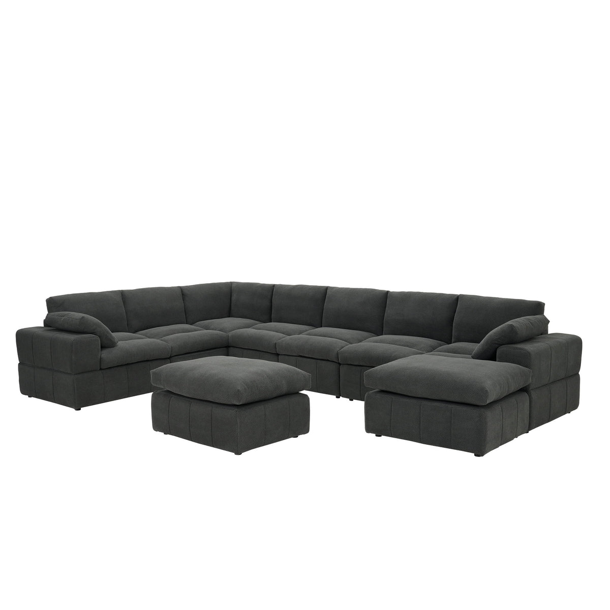 Dark gray L-shaped sectional sofa with broad arms, two ottomans and toss pillows