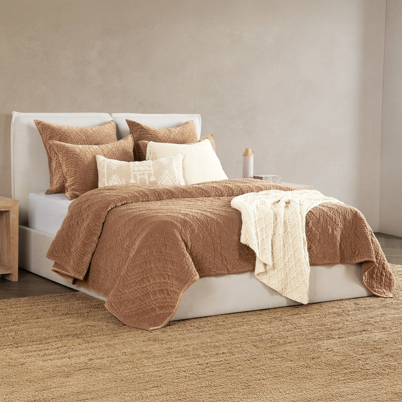 Taupe velvet bedding set with matching pillows and folded throw on bed