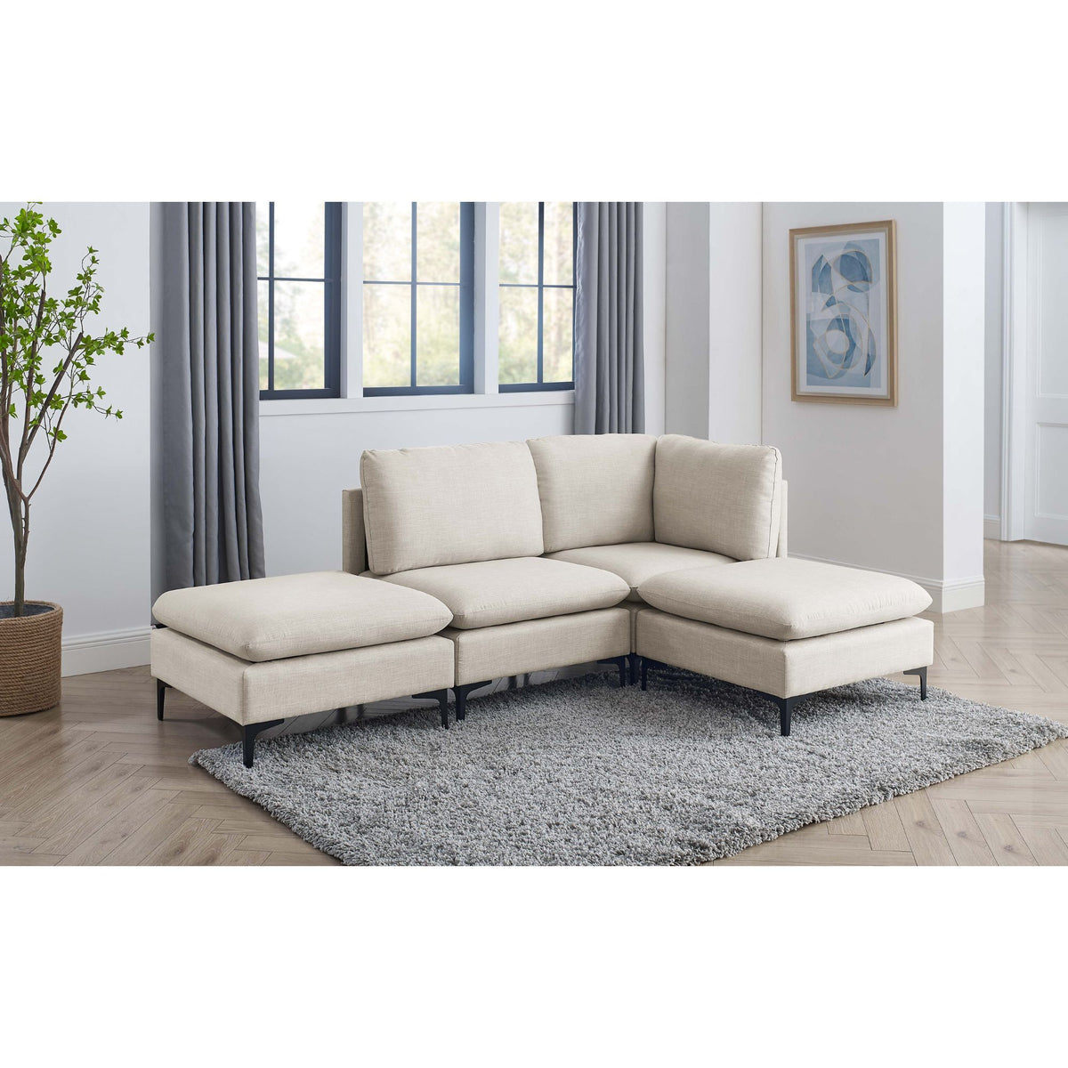Beige modular sectional sofa with tall legs, corner chaise and ottoman seats