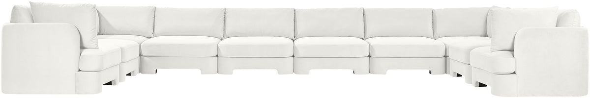 White velvet sectional sofa with modular seats and wide track-style arms