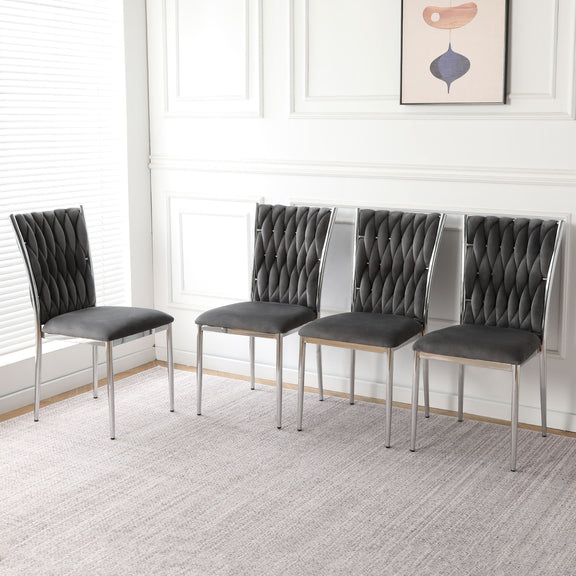 Set of four dark gray tufted dining chairs with chrome legs and padded seats