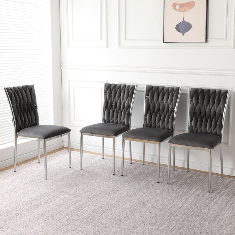 Set of four dark gray tufted dining chairs with chrome legs and padded seats