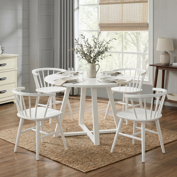 White round dining table with four Windsor chairs, spindle backs and straight legs