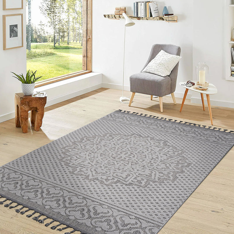 Medallion indoor/outdoor area rug with gray medallion motif and dark gray fringe tassels