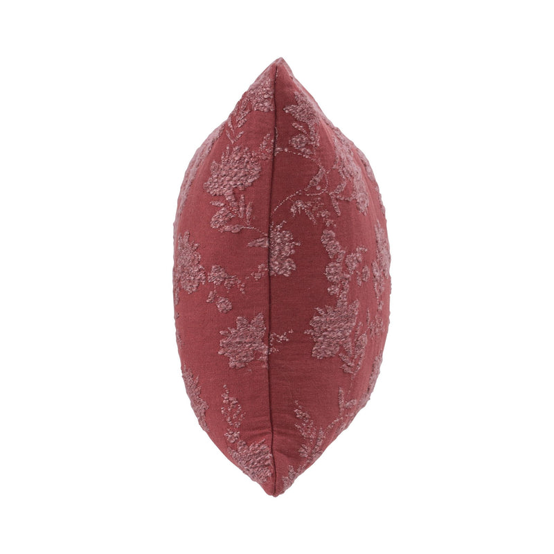 Burgundy red pillow with light floral vine pattern, close side view of seam detail.