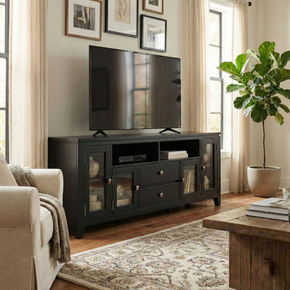 Wide dark TV media stand with glass-front doors, open shelves, and drawers