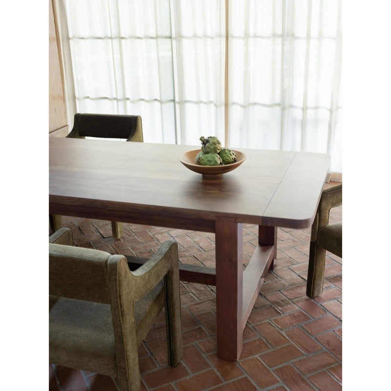 Warm brown dining table with beveled edges, centered leg, and two dining chairs.