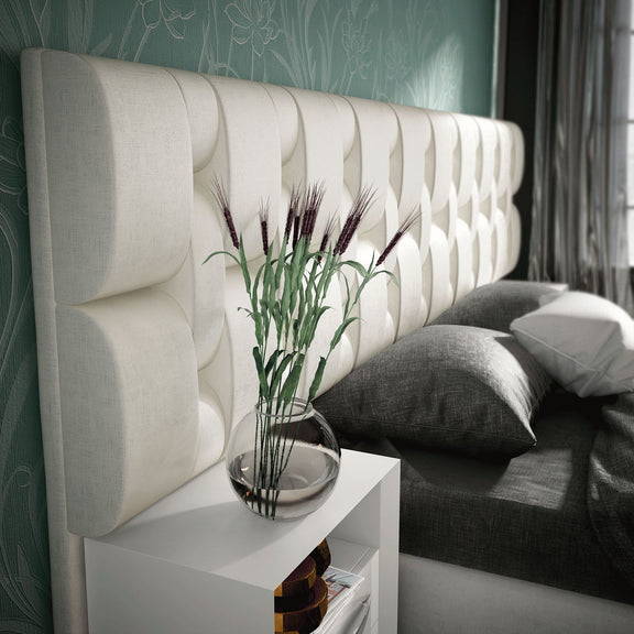 Emporio bed close-up with white slatted headboard and gray bedding
