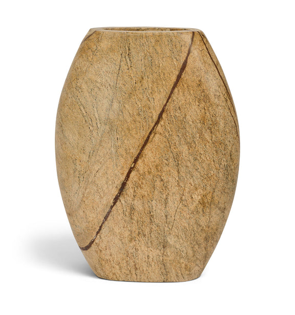Tan marble vase with long dark vein line and dark opening, faceted rounded shape.