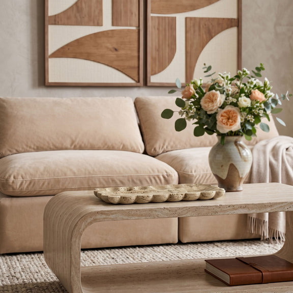 Beige travertine tray on dining table with bouquet centerpiece