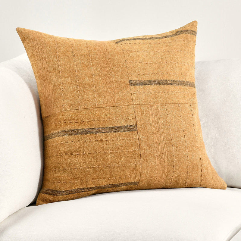 Chestnut brown square throw pillow with geometric patchwork and horizontal stripe details