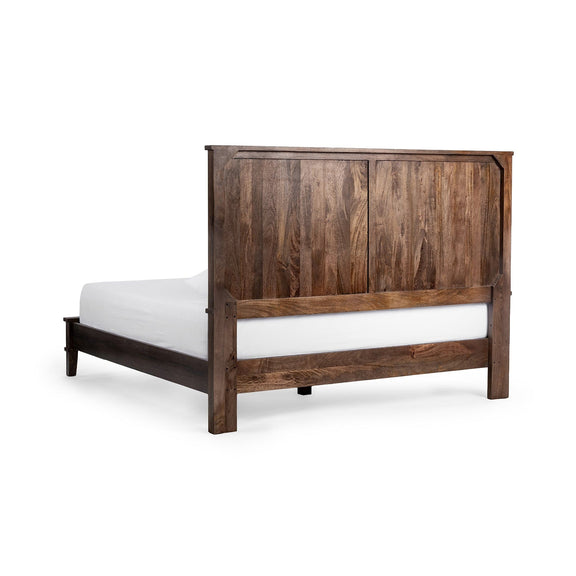 Brown solid wood bed with vertical-panel headboard, white mattress and pillows