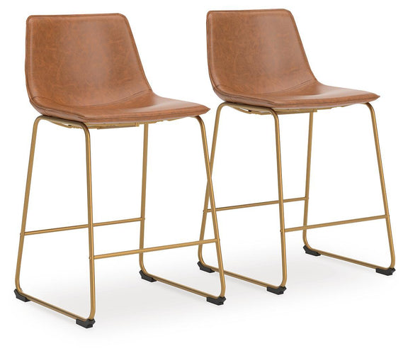 Set of 2 light brown upholstered barstools with curved backs, gold frames, and footrests