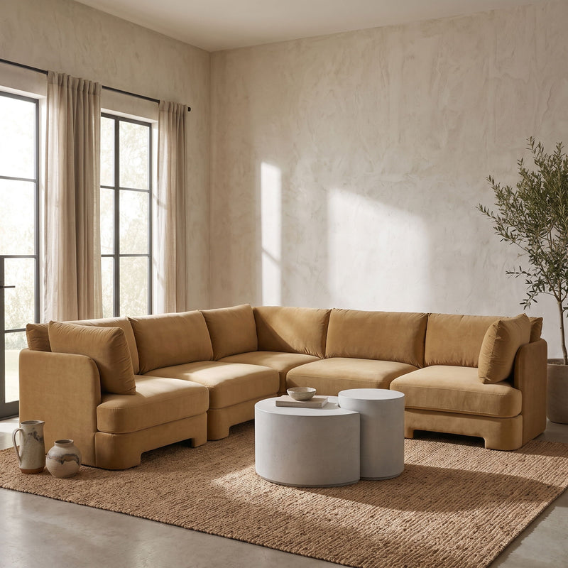 Light brown velvet corner sectional sofa in living room setting with chaise module.
