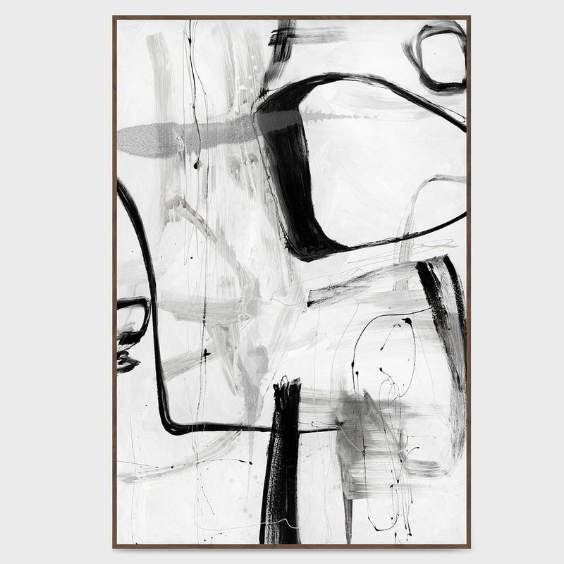 Framed abstract wall art with black brushstrokes on white background