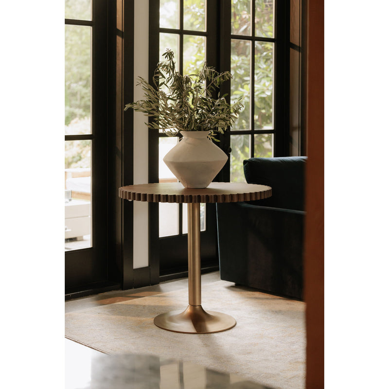 Round cafe table with dark brown scalloped top, gold base, and white vase greenery