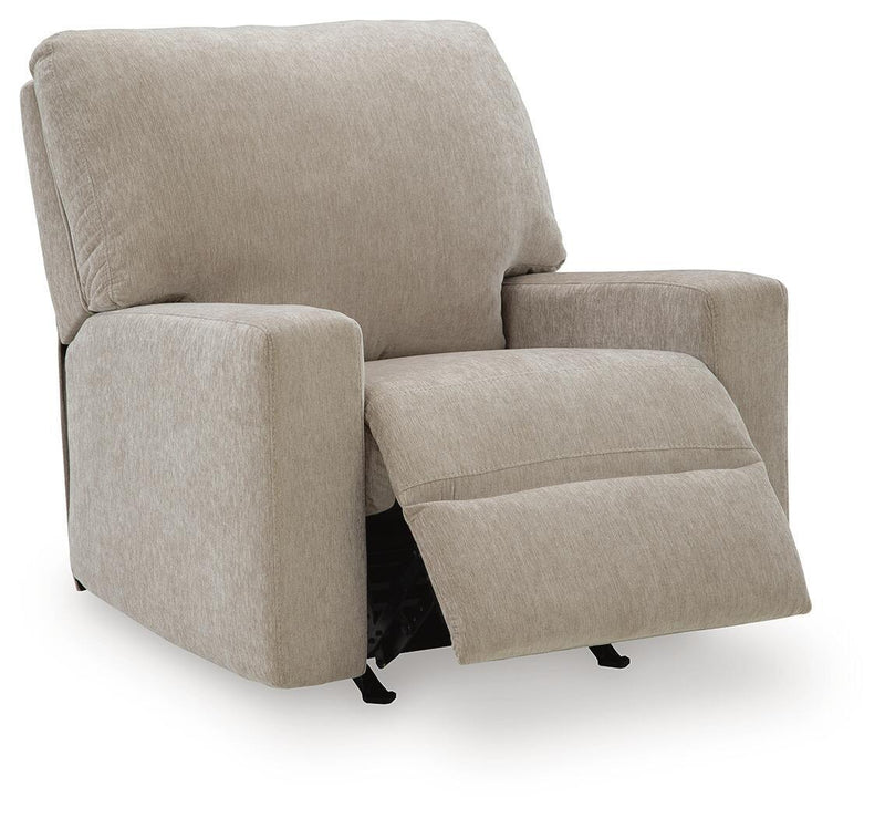 Beige fabric rocker recliner with extended footrest and thick, padded arms.