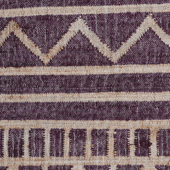 Close-up distressed rug with purple diamond pattern, cream stripes, and fringe