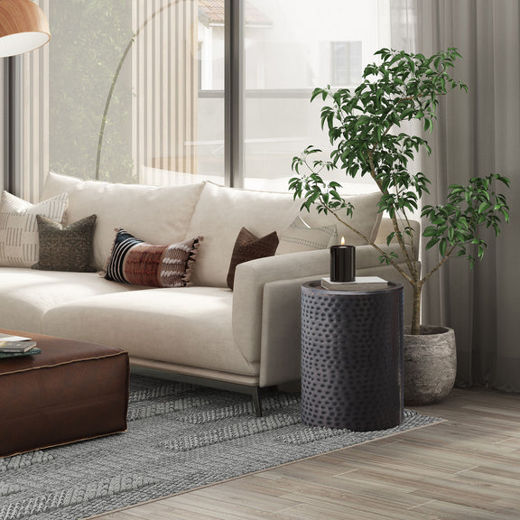 Corbin hammered metal side table, black drum accent table beside sofa