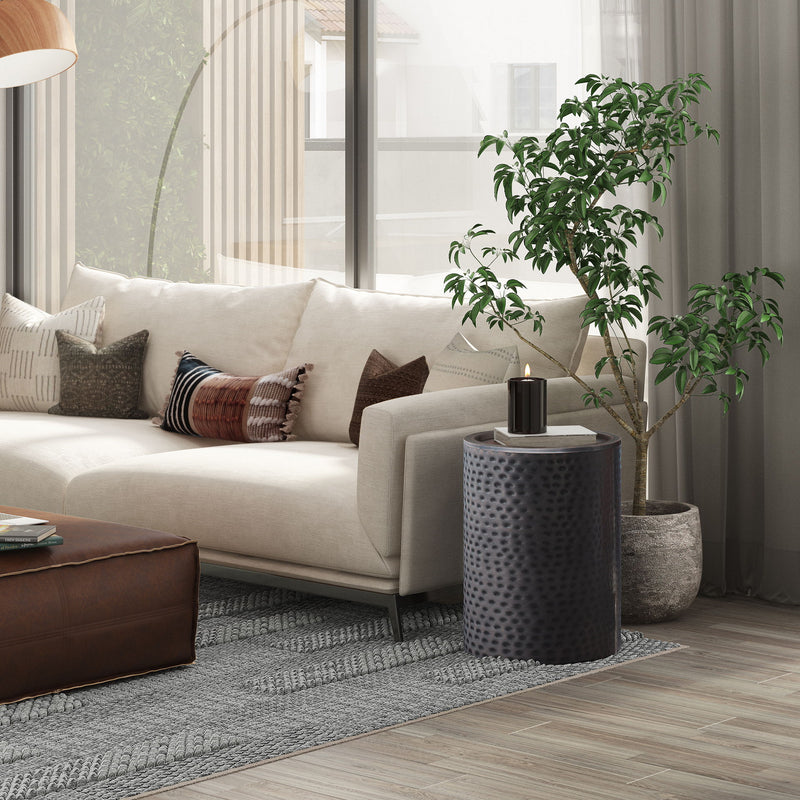 Corbin hammered metal side table, black drum accent table beside sofa