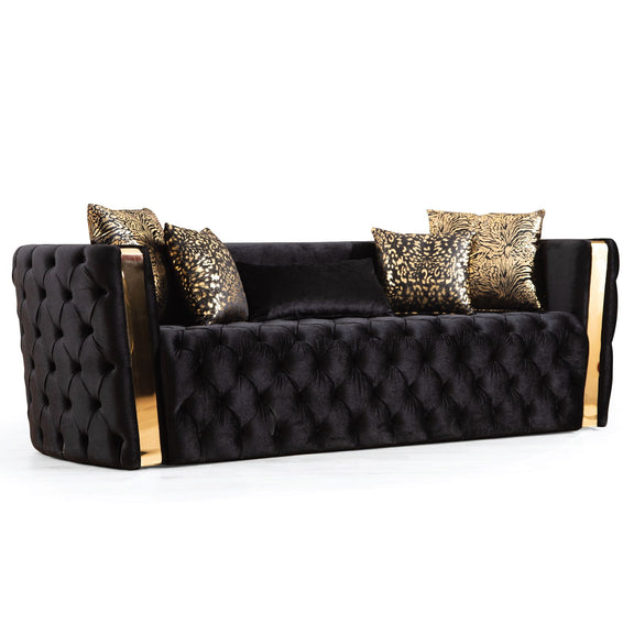 Black button-tufted sofa with gold-finish arm accents and patterned cushions