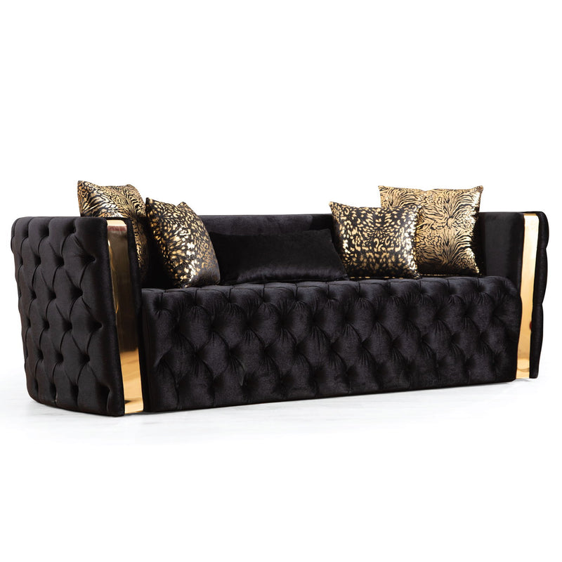 Black button-tufted sofa with gold-finish arm accents and patterned cushions