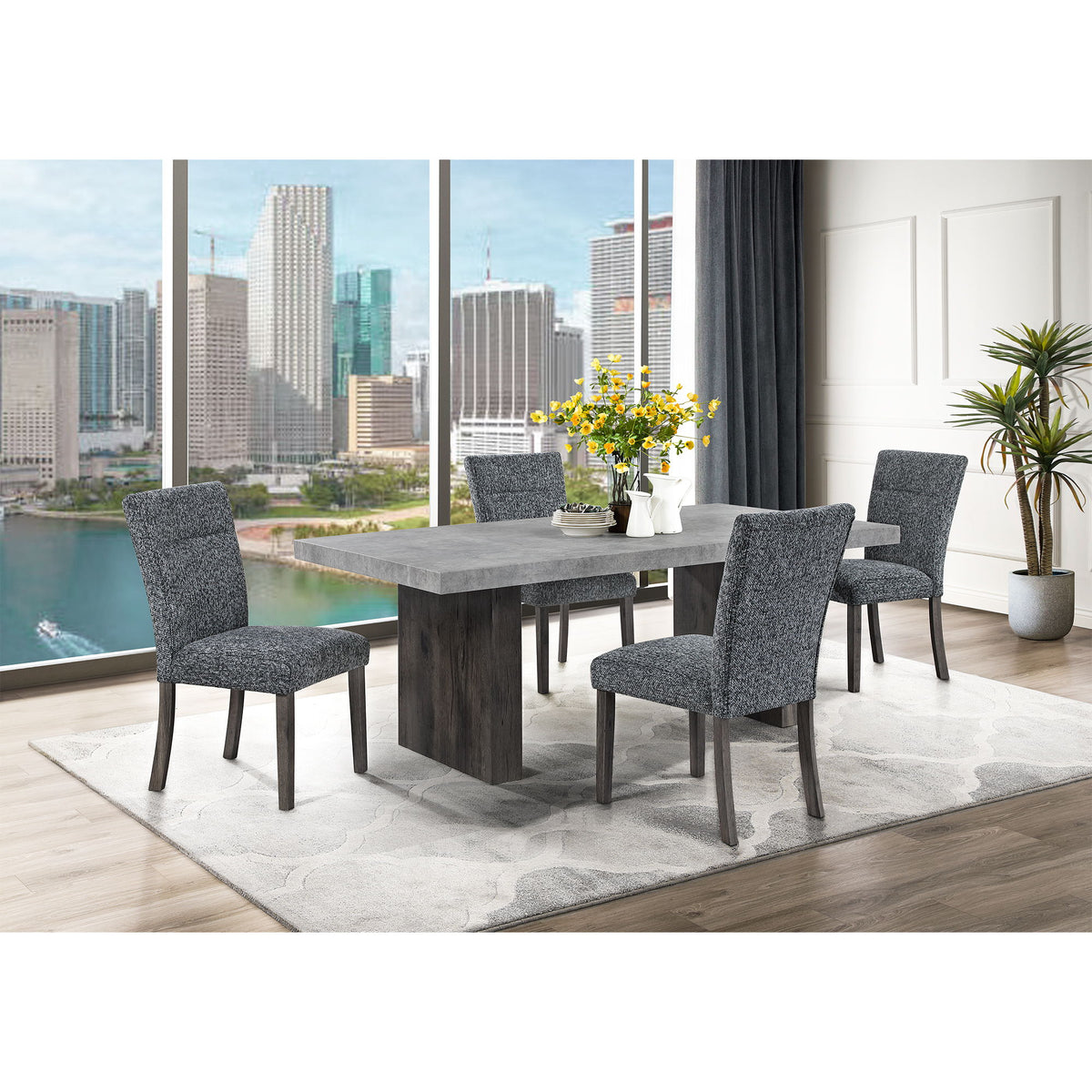 Gray dining table with matching upholstered chairs and dark wood legs