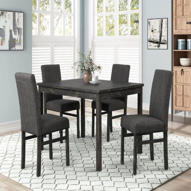 Dark gray upholstered dining chair set around a wood table, tall backs and padded seats