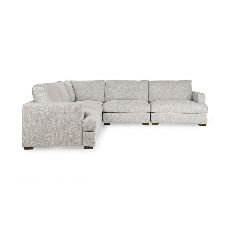 Ivory upholstered corner sectional sofa with chaise and padded armrests