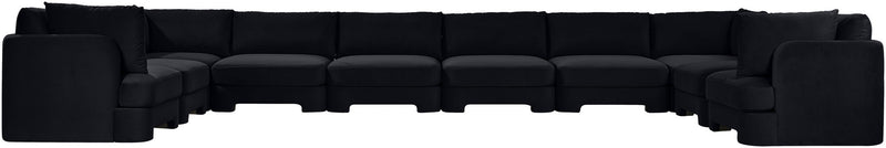 Black velvet sectional sofa with modular ottoman-style seats and cushioned back