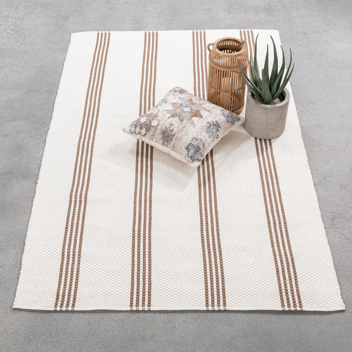 White and tan striped area rug with vertical dotted stripes, textured woven surface