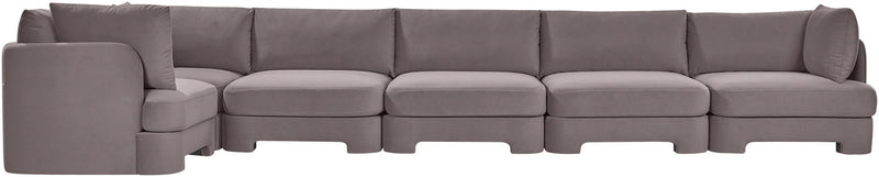 Gray velvet L-shaped sectional sofa with padded arms and tufted back cushions.