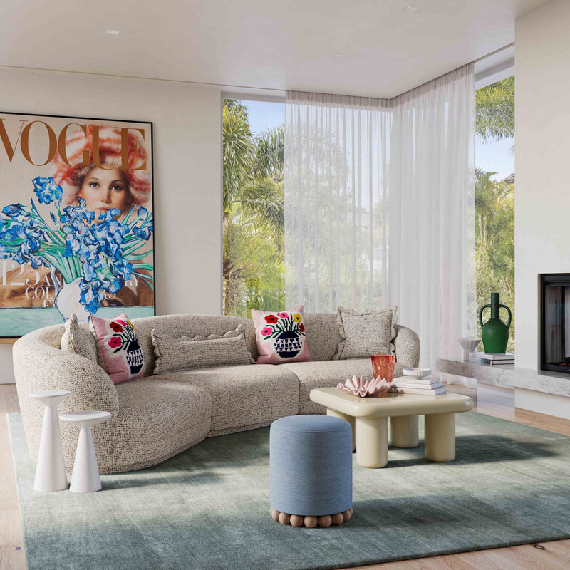 Light textured boucle sectional sofa with chaise and patterned throw pillows