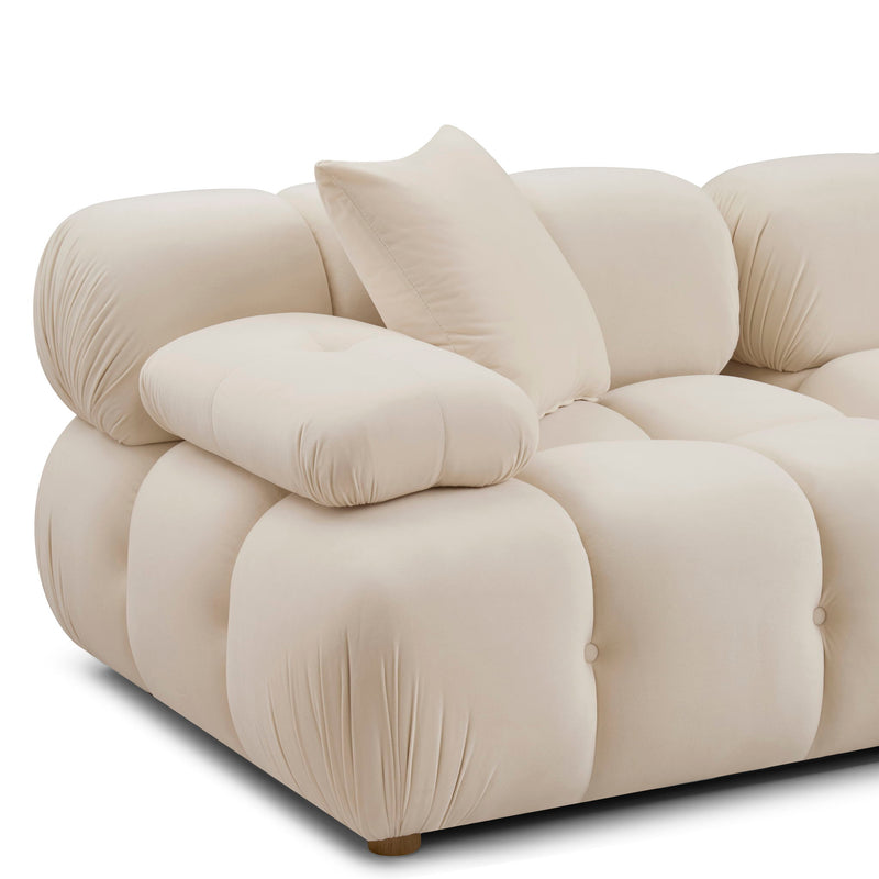 Cream modular loveseat sofa with curved padded arms, tufted cushions, and a wide chaise seat
