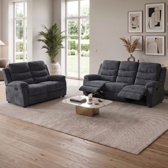 Dark gray reclining sofa set with attached headrests, shown in a living room setting