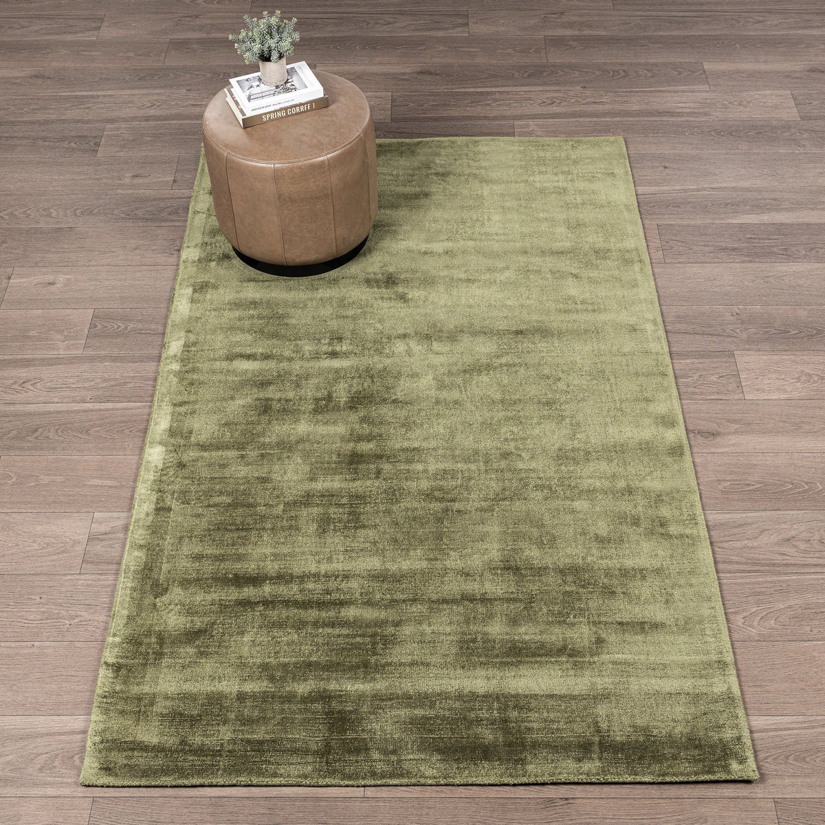 Green distressed area rug with softly mottled design and low, even pile.